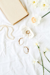 Minimal fashion French style composition with women's accessories: earrings, necklace, rings on...