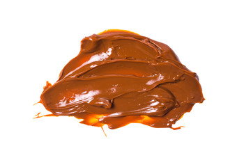 Melted tasty caramel splashes isolated on white background.