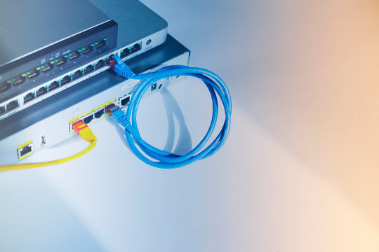 Enterprise equipment concept. Black and silver  cloud switches interconnected using bright cables on the white background. Rack mount routers. Space for your text. Closeup