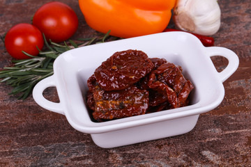 Dried tomatoes in the bowl with olive oil