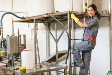 Woman climbing stairs in olives factory