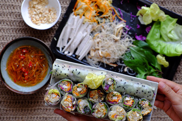 sliced vegan rice paper rolls on spring roll ingredient background