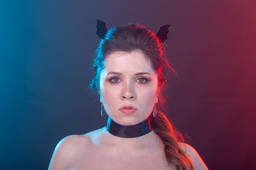 Halloween, holidays and carnival concept - vamp woman in gothic style.