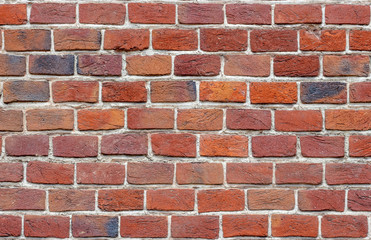 Obraz premium Gray red brown brick wall background, close-up view.