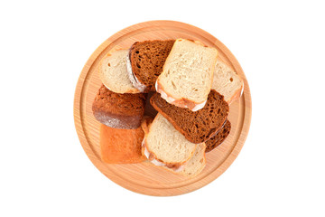 Fresh bread on a wooden round board isolated on white background
