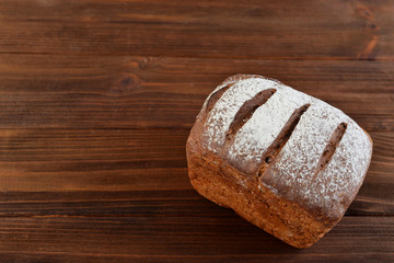 Homemade fresh bread on a wooden background