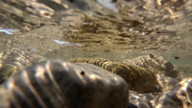 Sea waves hitting and flooding rocky shore