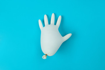 Latex glove inflated on a blue background.Health concept. Healthy lifestyle concept. The concept of pharmacology. The concept of medicines. The concept of medicine. The concept of latex products.