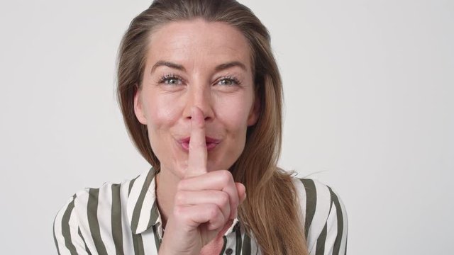 Beautiful Woman With Finger On Lips