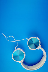 blue white color headphone on a blue background