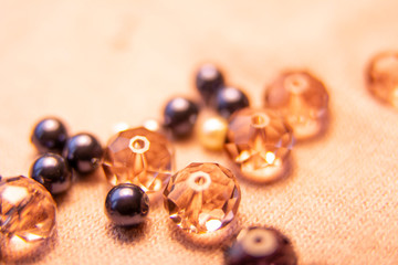 Colorful glass beads and crystals. Variety of shapes and colors to make a bead necklace or a string of beads for women.Blurred photo.