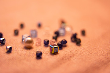 Colorful glass beads and crystals. Variety of shapes and colors to make a bead necklace or a string of beads for women.Blurred photo.