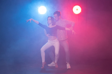 Social dance, kizomba, salsa, semba or zouk concept - a young couple dancing bachata and salsa at...