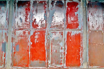 frames pattern steel Facade of an old industrial building. cracked distressed paint on old wall of an Factory Building. Old red painted Metal Doors