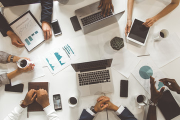 top view work workplace. A team of young office workers, businessmen with laptop working at the...