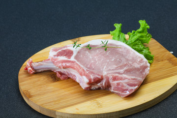 Raw pork bone steak over wooden