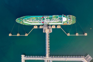 Aerial top view of the ship carrying the lpg and oil tanker in the sea port. For energy export and import business for transportation - obrazy, fototapety, plakaty