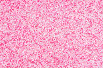 pink sprinkles over pink like background, top view