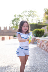 beautiful girl  Shooting Bubbles from Bubble Gun in the park