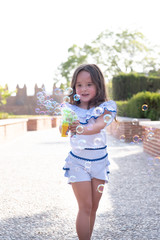 beautiful girl  Shooting Bubbles from Bubble Gun in the park