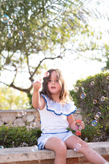 beautiful girl  Shooting Bubbles from Bubble Gun in the park