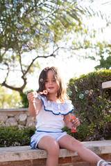 beautiful girl  Shooting Bubbles from Bubble Gun in the park