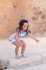 girl with blue and white clothes jumping a step
