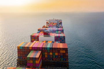 top aerial view of the large volume of TEU containers on ship sailing in the sea carriage the shipment from loading port to destination,  heading to the destination of success light - obrazy, fototapety, plakaty