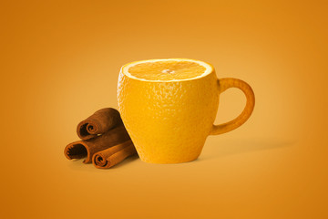 Cup concept with orange texture on an orange background. Near the cup are cinnamon sticks.
