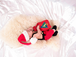 cute four-month baby  santa  with Christmas red dress