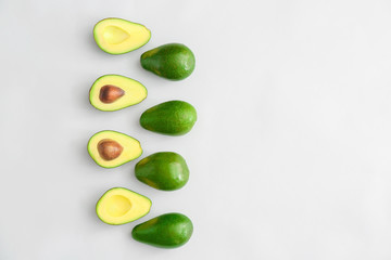 Fresh ripe avocados on white background
