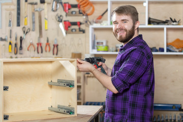 Manufacturing, Small-Sized Companies and worker concept - man working on the furniture factory