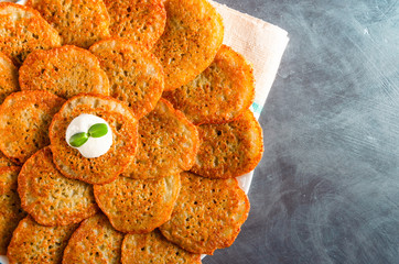 Homemade potato pancakes, latkes, draniki, hash browns or fritters served with sour cream and...