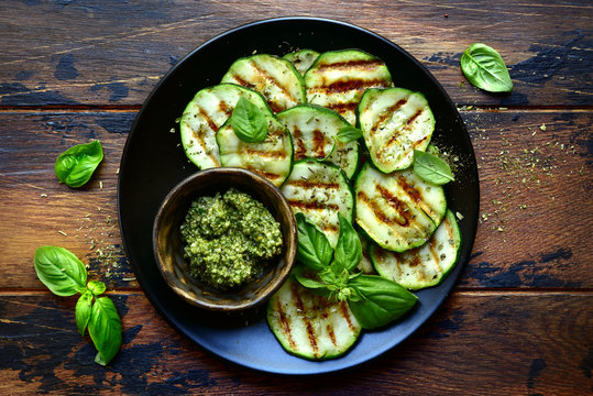 Grilled zucchini slices with basil pesto.Top view with copy space.