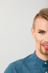 Portrait of young transgender woman on light background