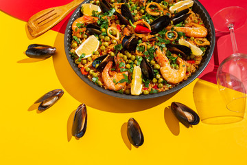 Spanish paella with seafood on the background of the Spanish flag
