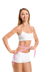 Beautiful young woman with measuring tape on white background. Weight loss concept