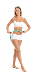 Fototapeta premium Beautiful young woman with measuring tape on white background. Weight loss concept
