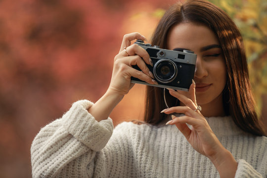 Woman photographer take a photo of the autumn nature