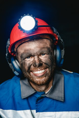 Portrait miner coal man in helmet with lantern in underground mine. Concept industrial engineer