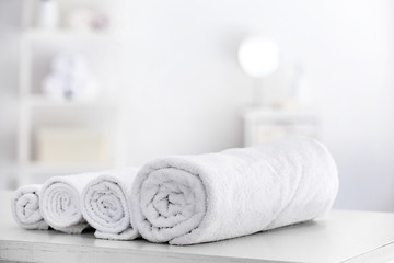 Soft clean towels on table in bathroom