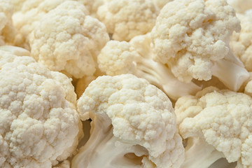 Cauliflower cut into pieces lies on the table