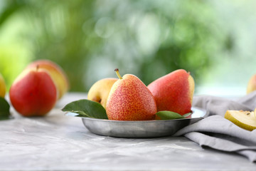 Tasty ripe pears on table outdoors