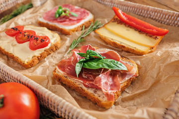 Different tasty sandwiches on tray, closeup