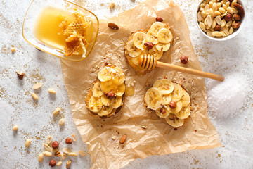 Tasty sweet sandwiches with honey on white background