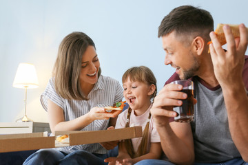Obraz na płótnie Canvas Happy family eating pizza at home