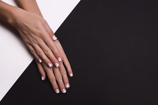 Beautiful Hands With French Manicure On Black Background