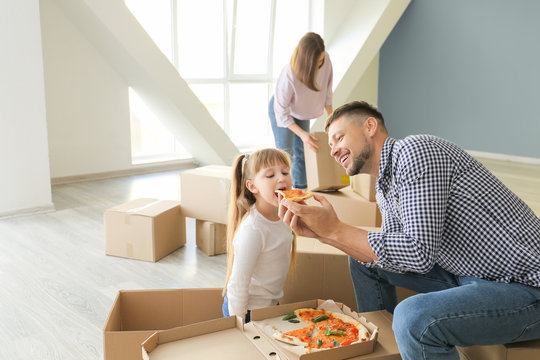 Happy Family Eating Pizza On Moving Day