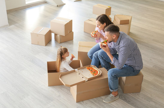 Happy Family Eating Pizza On Moving Day