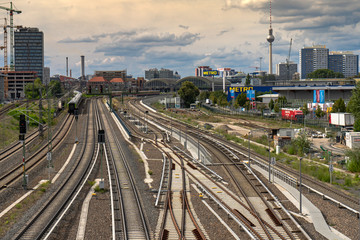 Beautiful panoramic view of the city of Berlin. At the front of the cityscape are railway tracks stretching into the distance.
